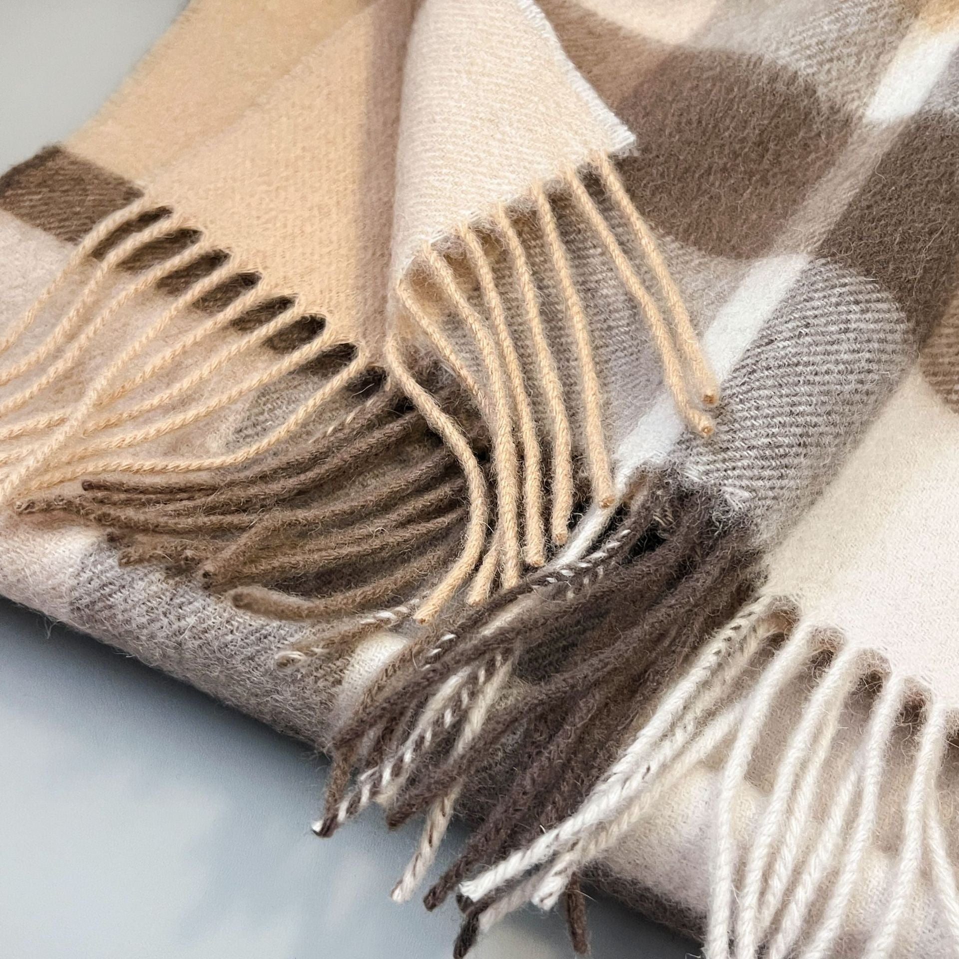 Pure wool scarf with plaid pattern and soft fringe in neutral beige and brown tones