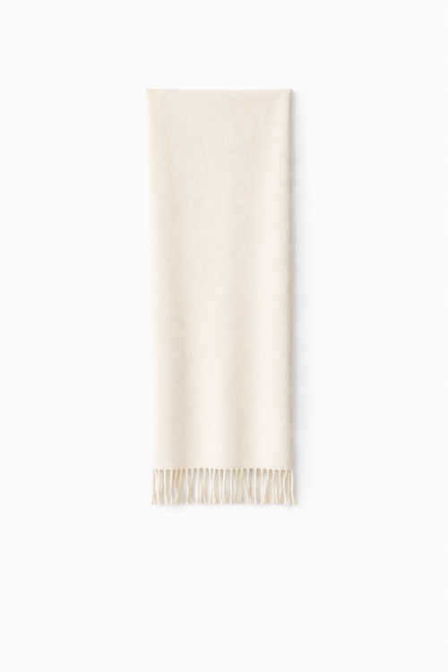 Thick wool scarf in ivory laid flat on a white background